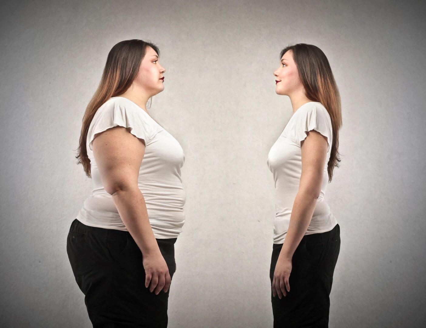 A woman standing in front of another woman 's reflection.